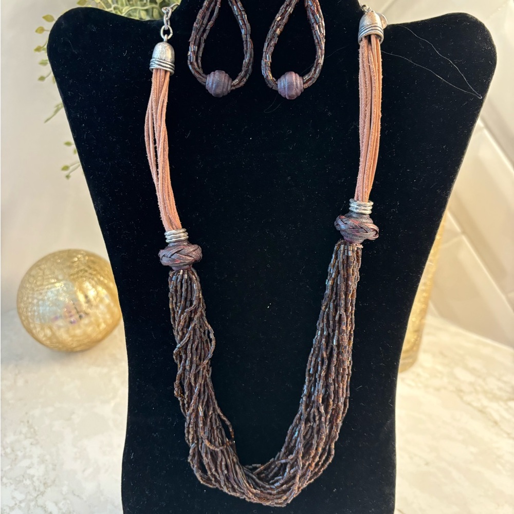 Chico’s brown beaded and rawhide necklace with coordinating earrings.